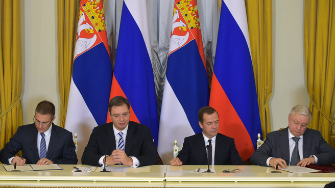 Signing documents following Russian-Serbian talks