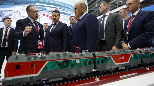 Mikhail Mishustin and Prime Minister of Kazakhstan Alikhan Smailov tour INNOPROM 2022. The Metallurgical Pipe Company and Sinara Group stand. A brief presentation of the Malachite electric locomotive. General Director of Sinara Group Mikhail Khodorovsky (left)